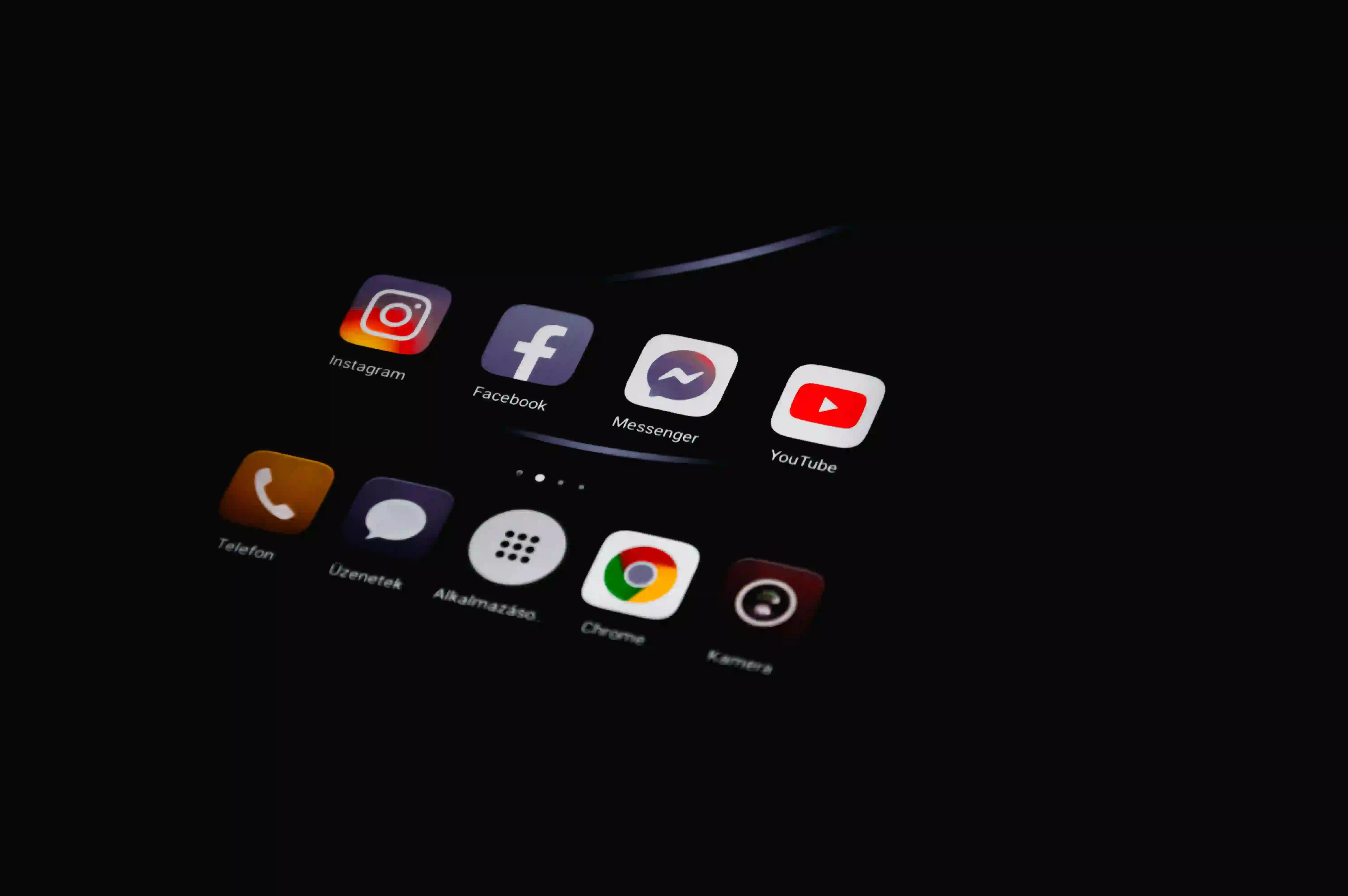 Close-up of a smartphone screen displaying app icons including Instagram, Facebook, Messenger, and YouTube, with a focus on YouTube thumbnail size optimization